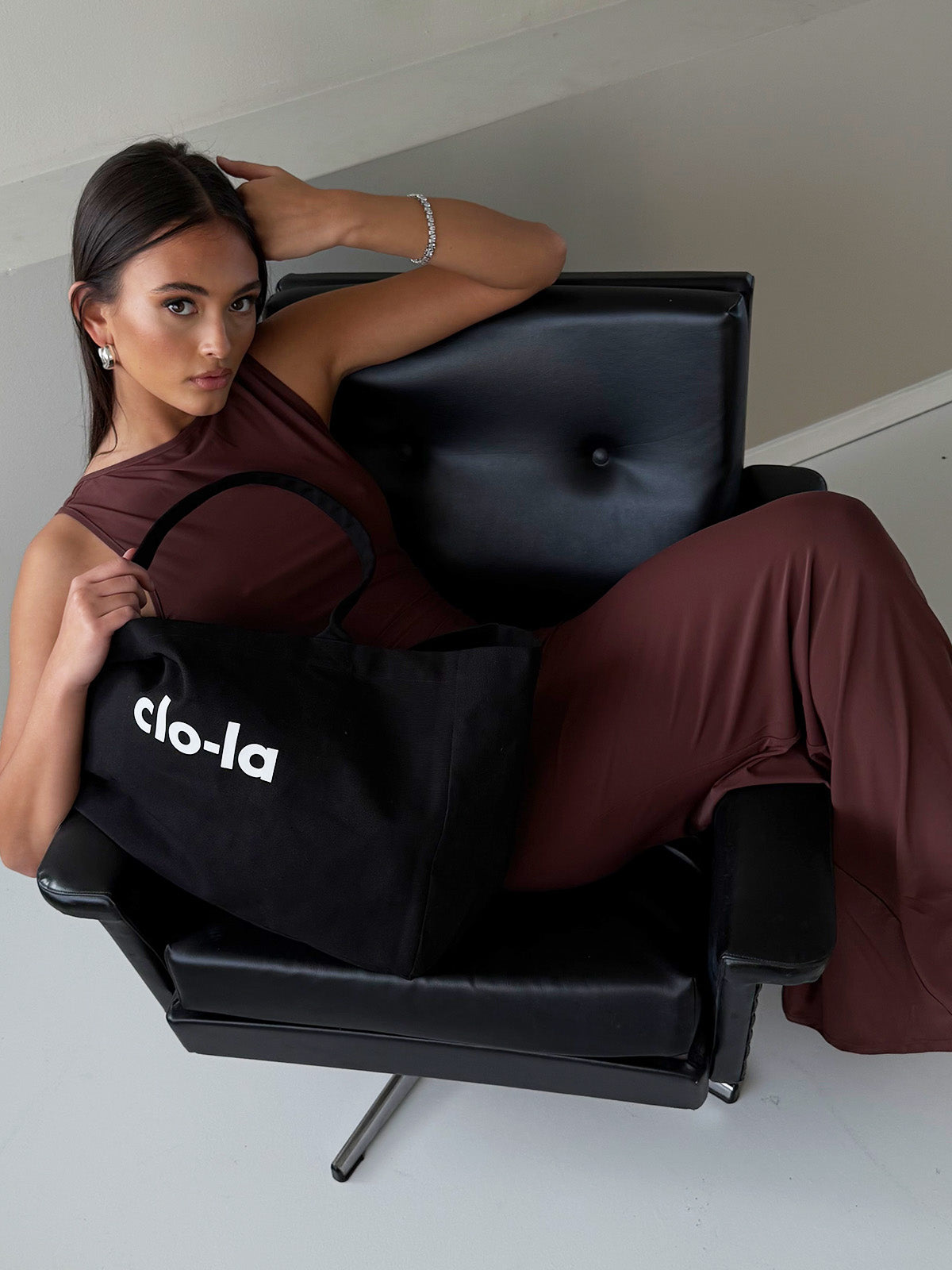 Black canvas tote bag styled as everyday carryall and travel bag
