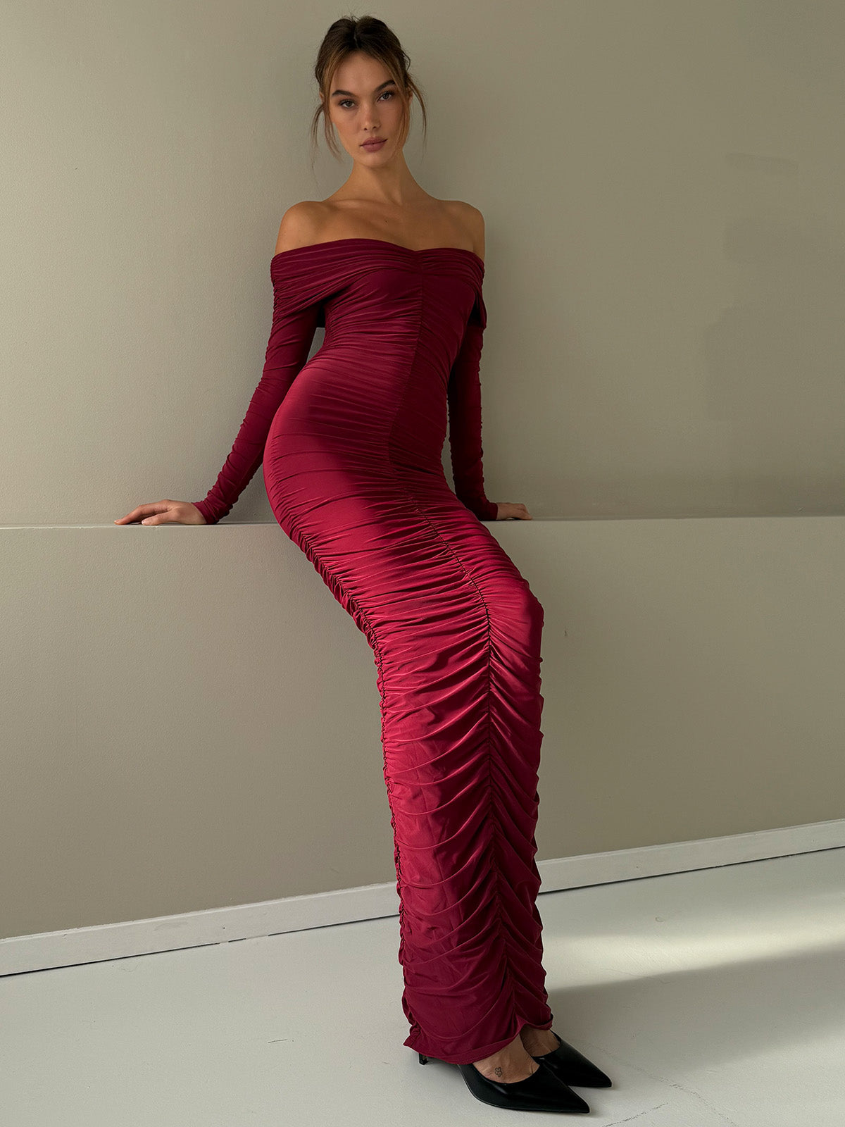 Burgundy off-shoulder maxi dress styled for resort or evening wear