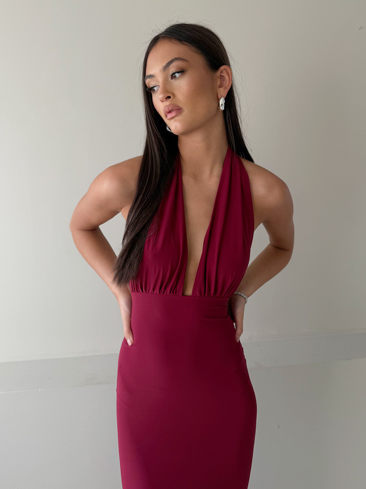 Burgundy halter neck maxi dress with adjustable draped bust detail