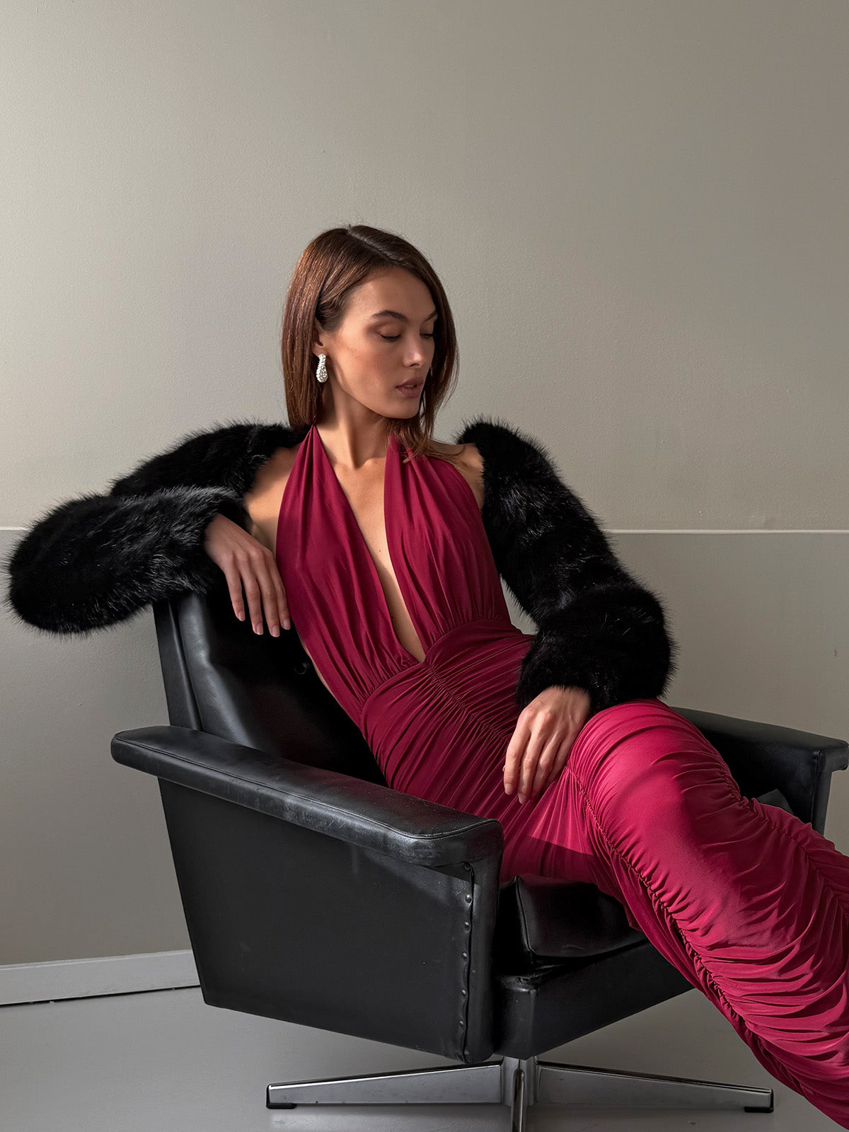 Burgundy ruched dress paired with faux fur bolero for elevated night look