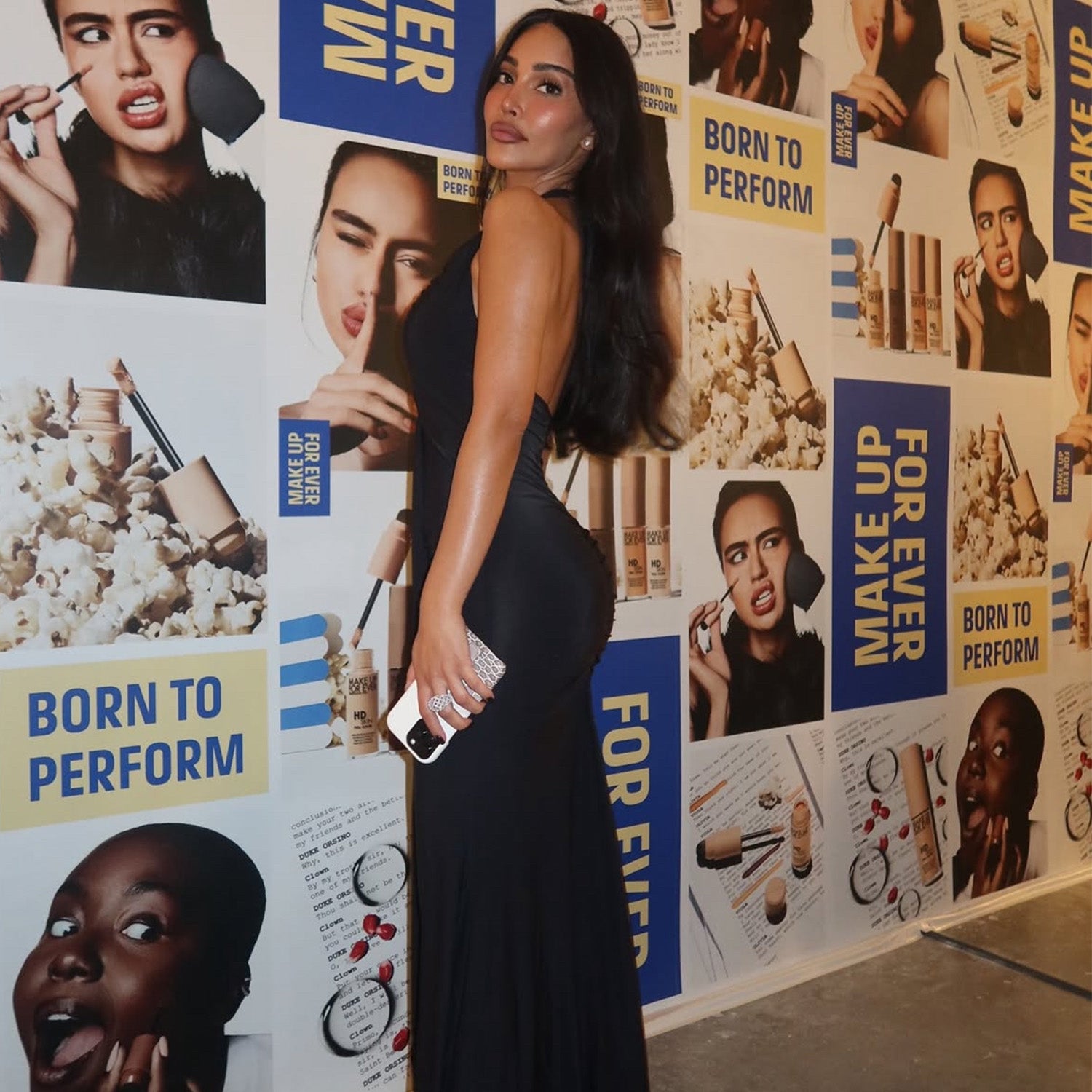 Black maxi dress with a smooth second-skin fit and an elegant open-back silhouette.