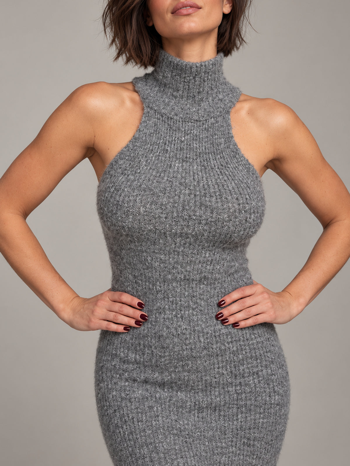 Belle dark grey knit dress, front detail with hands on waist