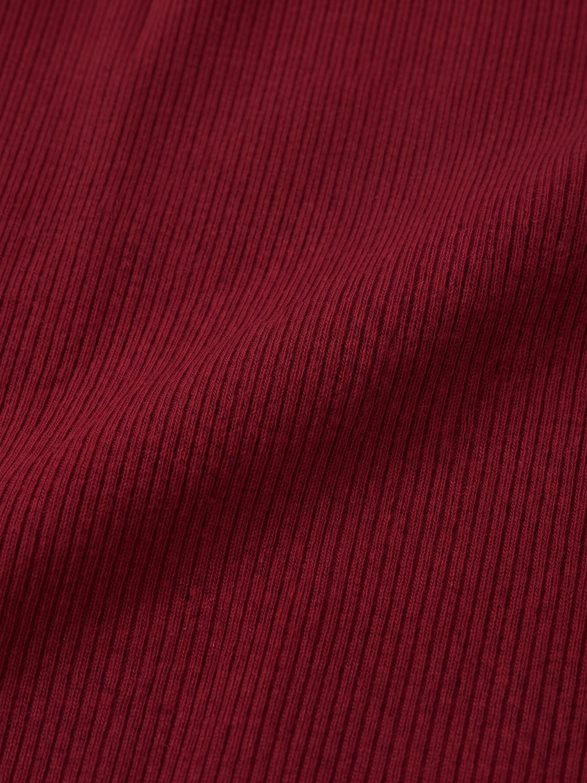 BREE Burgundy fabric swatch, close-up of the very fine vertical rib-knit texture and burgundy color.