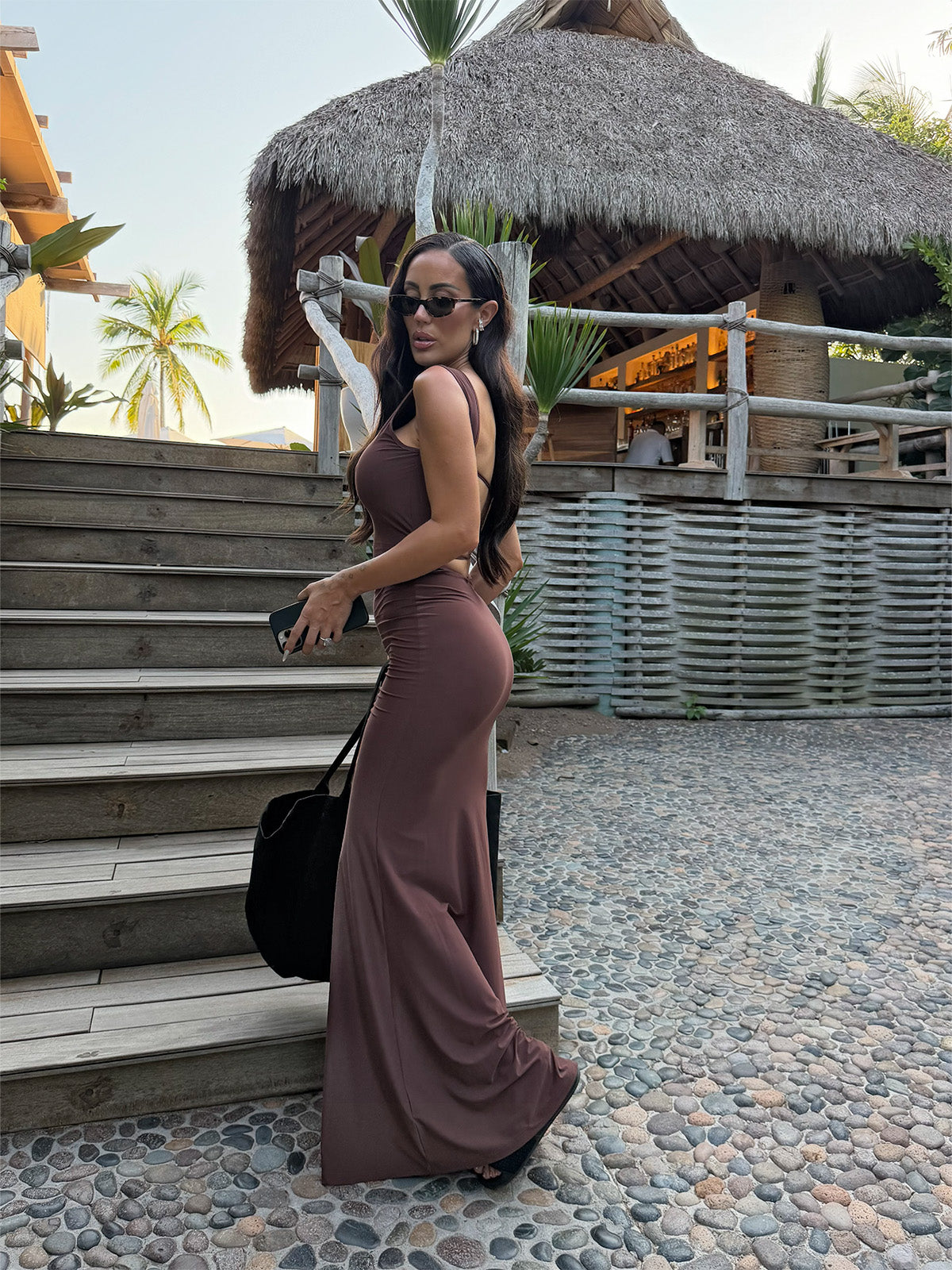 Side view of brown maxi dress with clean lines and figure-hugging fit