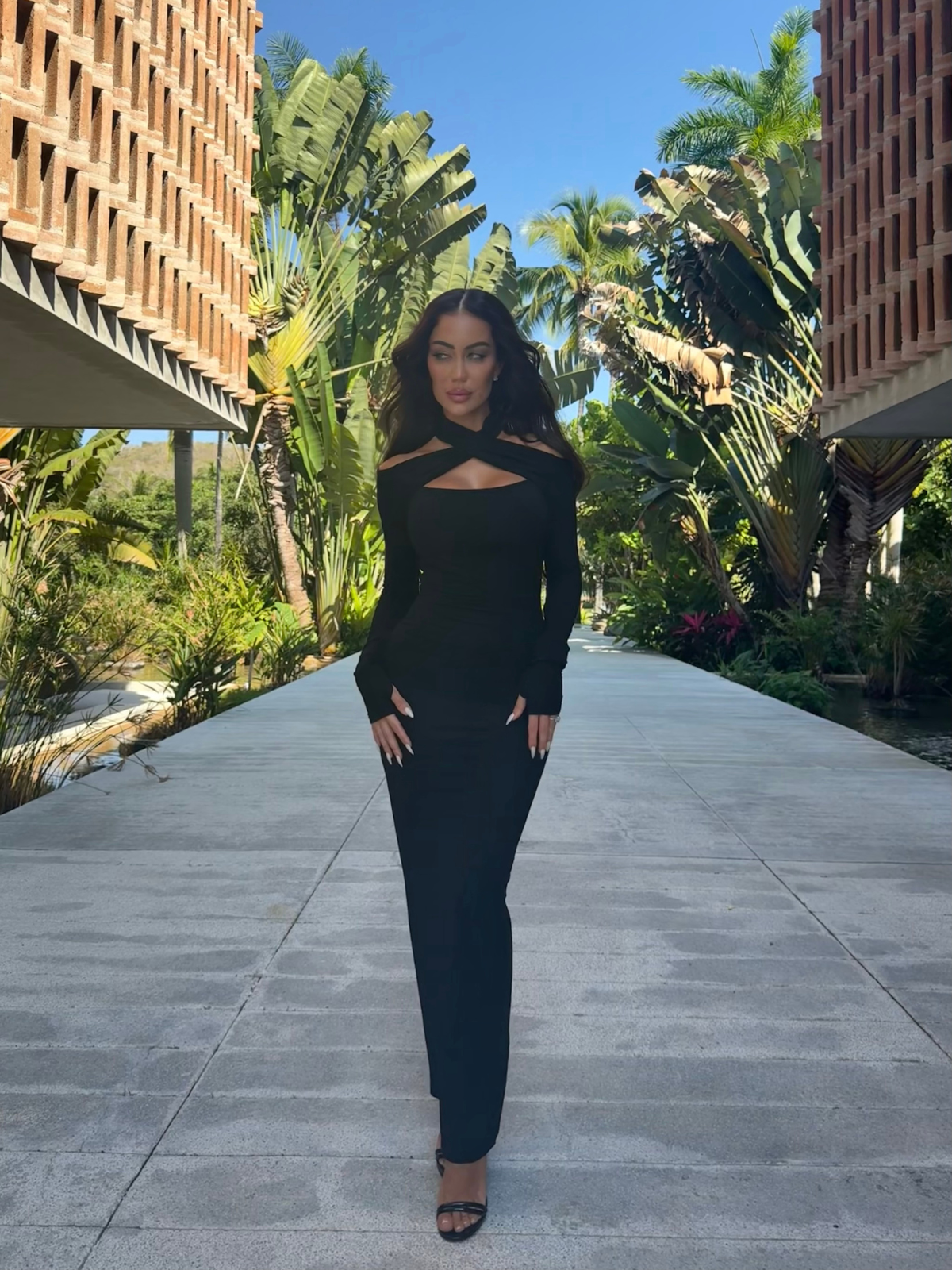Black bodycon maxi dress with long sleeves outdoor profile view