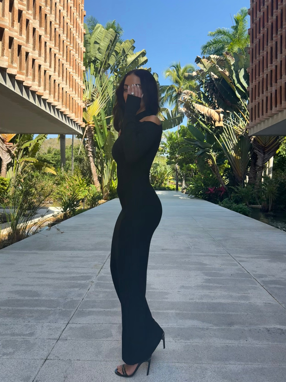 Black bodycon maxi dress with long sleeves outdoor side view