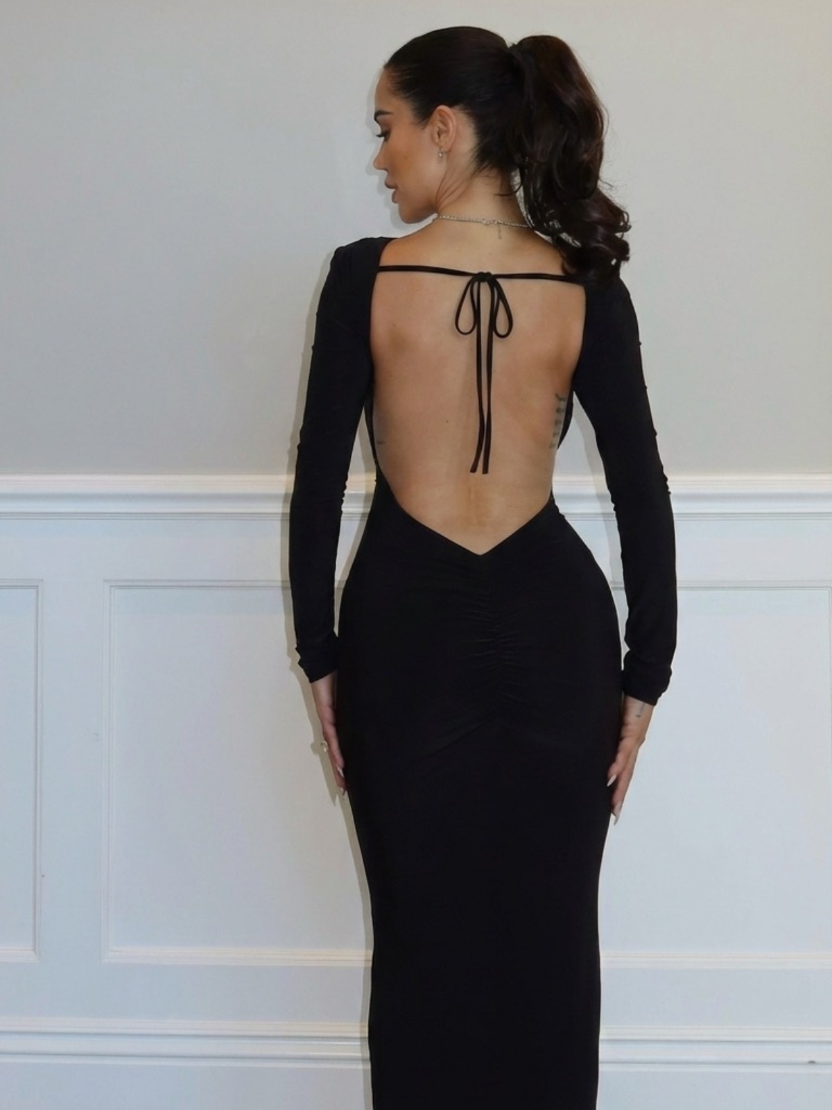 Black open back maxi dress with tie back detail and long sleeves