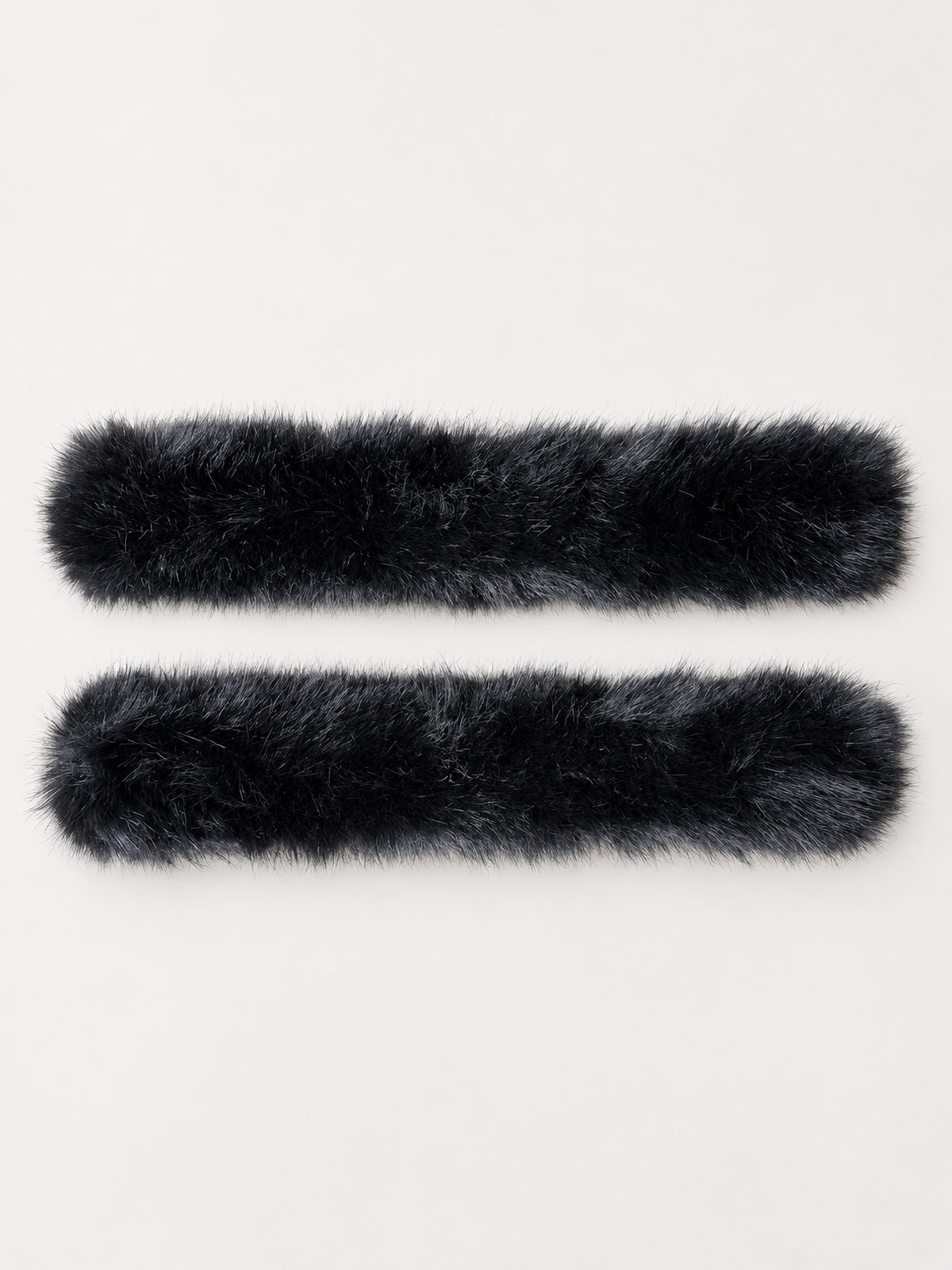 Black faux fur slap cuffs laid open, showing both bands