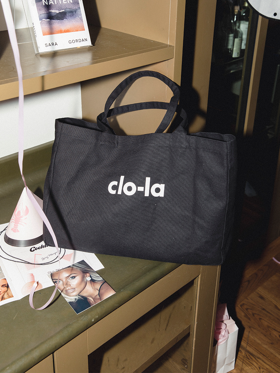Black canvas tote bag used as travel and weekend bag