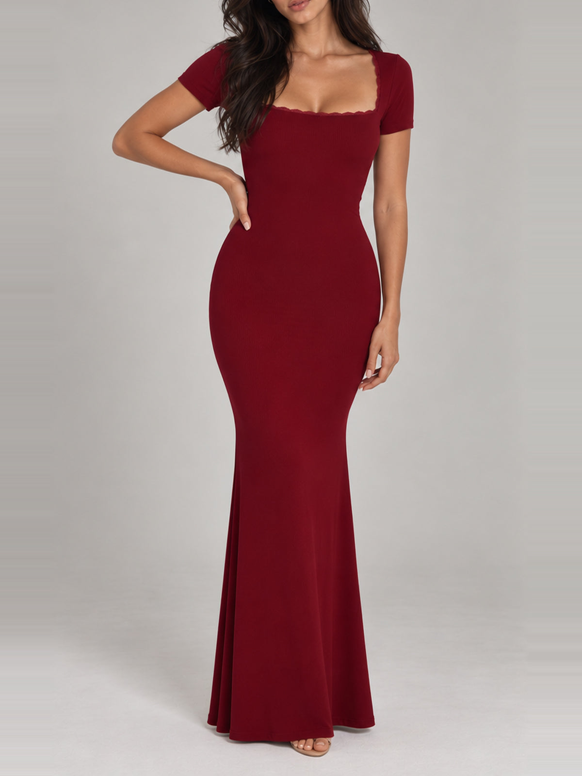 BREE Burgundy maxi dress, faceless front view with hand at the waist, fitted short sleeves and fine ribbed fabric.