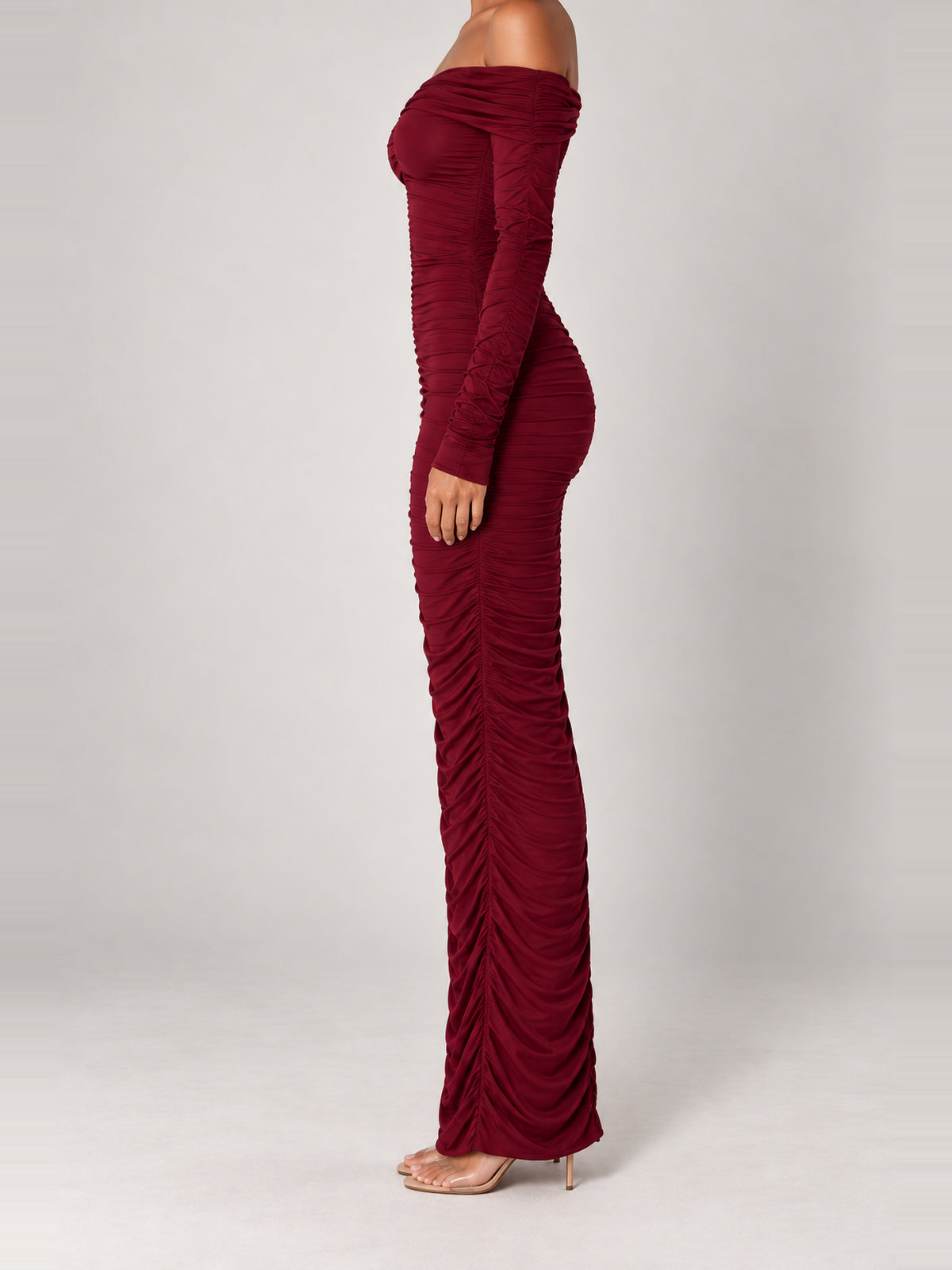 CHRISTA burgundy ruched maxi dress, side view showing the fitted silhouette and long sleeves.