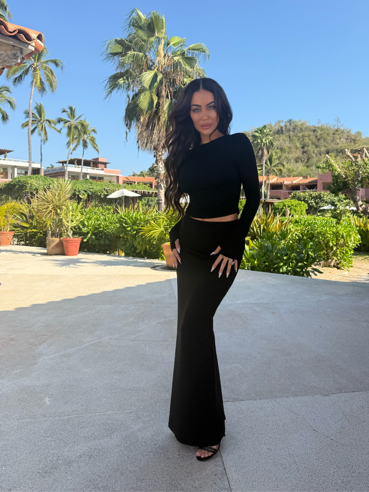 Black bodycon matching set with long sleeve crop top and high waisted maxi skirt, full length outdoor view