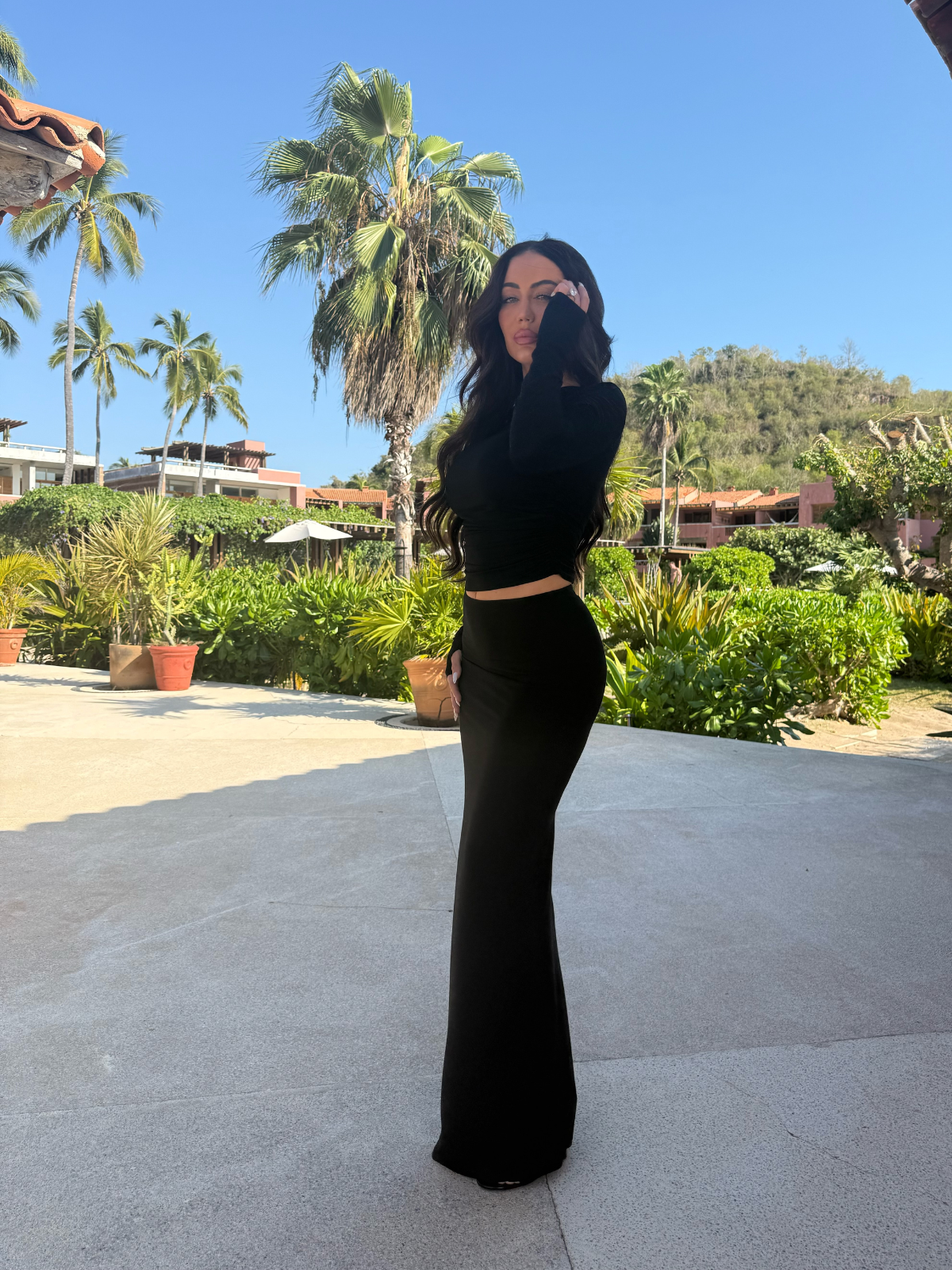 Black co-ord two piece set with bodycon maxi skirt and fitted crop top, standing outdoor view