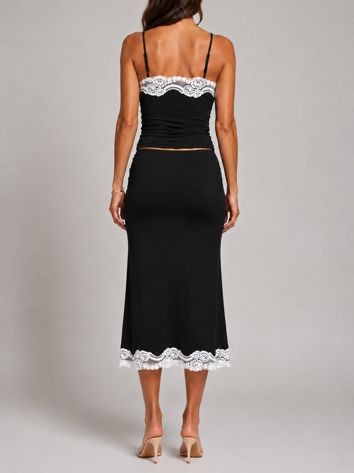 SUKI Black top and skirt with white lace, back view, faceless
